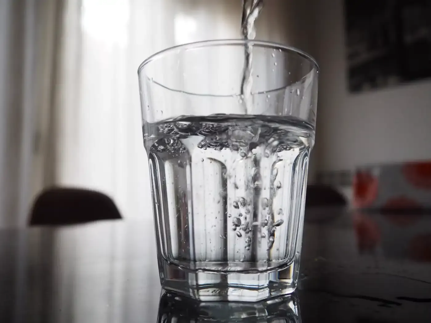 Clear water being poured into a glass
