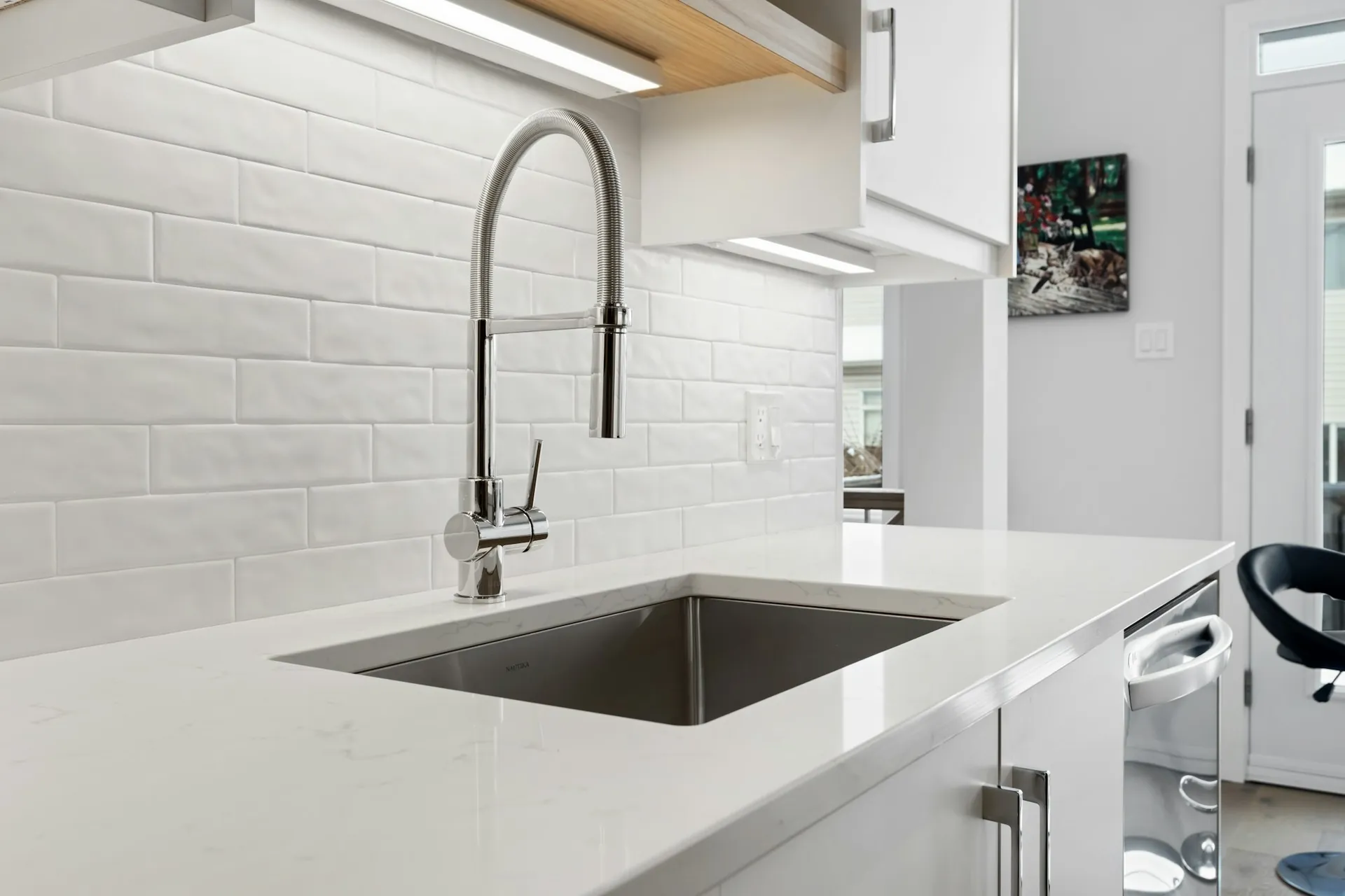 A kitchen sink beside a sunny window